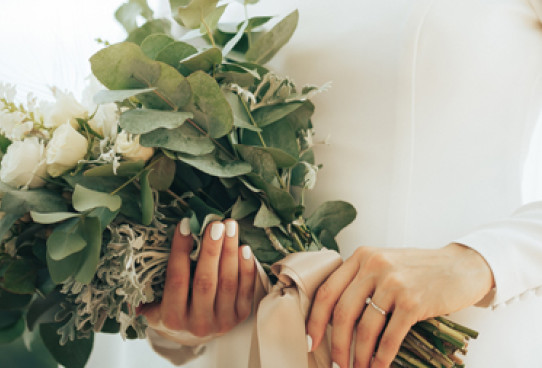Bride holding bouquet of flowers close to her web