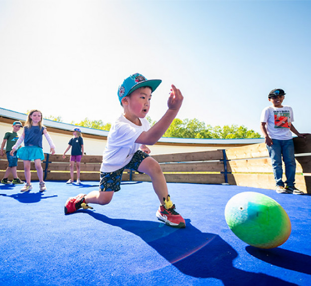 Children playing gaga ball on a court at WinSport